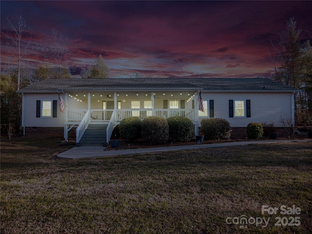 view of front facade featuring a lawn and crawl space