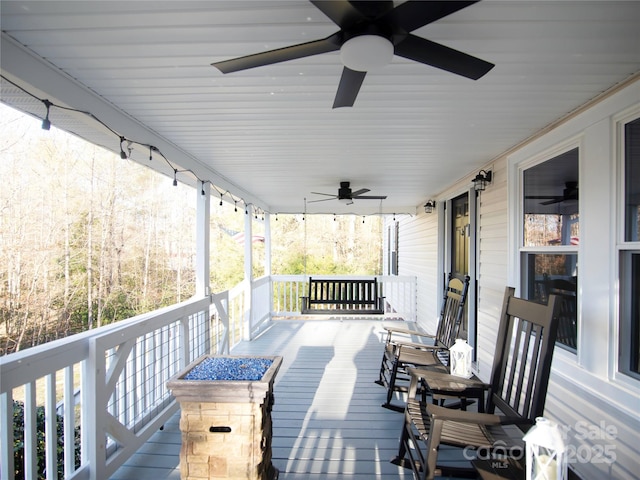 wooden deck with covered porch and ceiling fan