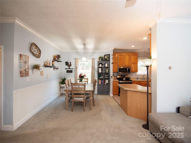 dining space featuring recessed lighting, baseboards, light colored carpet, and ornamental molding