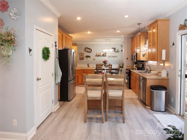 kitchen featuring a kitchen island, a sink, stainless steel appliances, light countertops, and crown molding