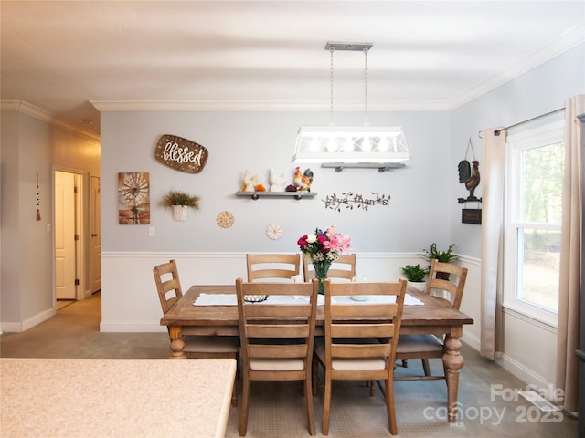 dining space featuring ornamental molding, baseboards, and carpet floors