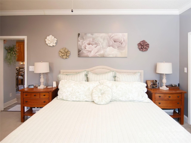 bedroom featuring carpet flooring, crown molding, and baseboards