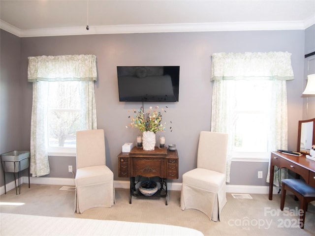 sitting room with light colored carpet, crown molding, and baseboards