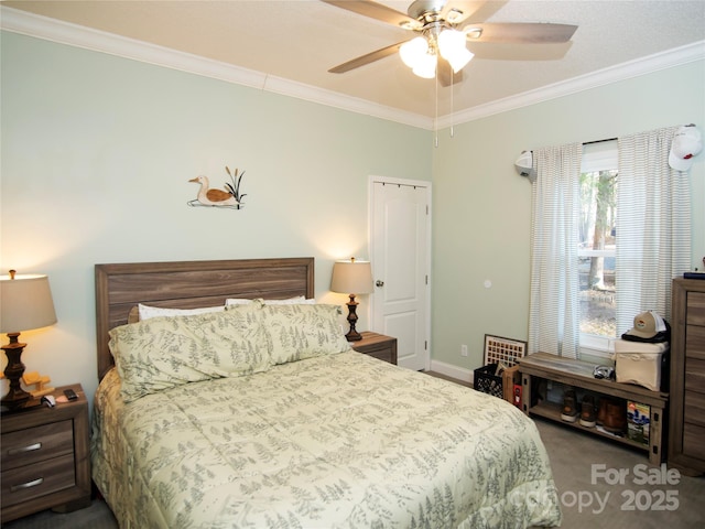 bedroom with a ceiling fan, crown molding, carpet, and baseboards