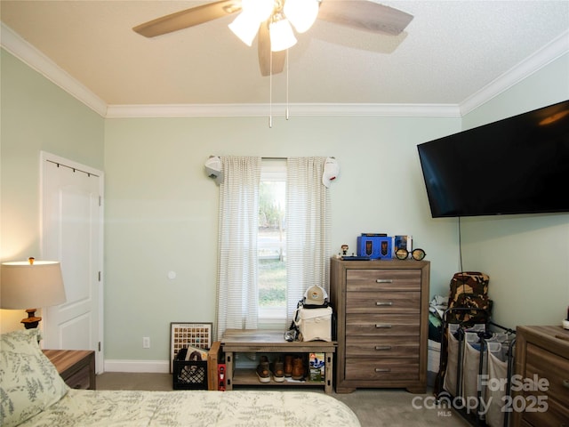 bedroom featuring baseboards, a ceiling fan, carpet, and ornamental molding