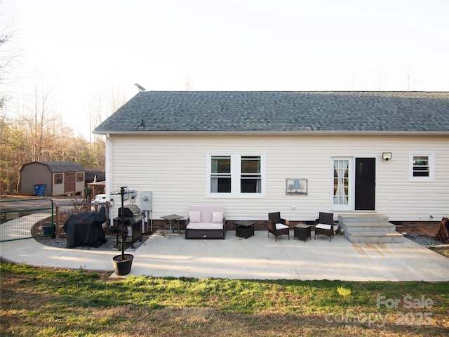 rear view of house with a storage unit, entry steps, a patio, an outdoor structure, and outdoor lounge area