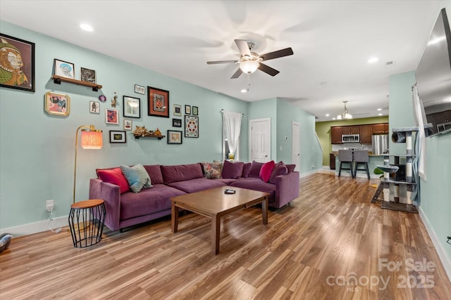 living room featuring recessed lighting, baseboards, light wood-type flooring, and ceiling fan