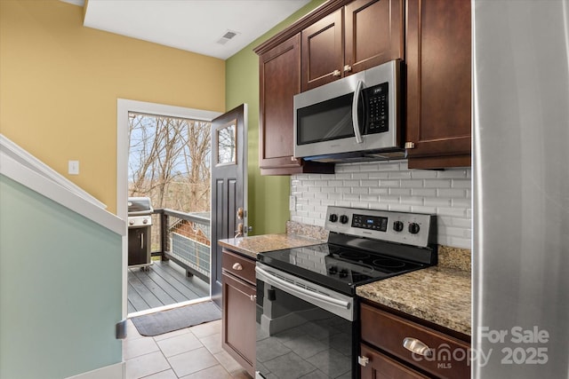 kitchen featuring visible vents, tasteful backsplash, dark brown cabinetry, appliances with stainless steel finishes, and light tile patterned flooring