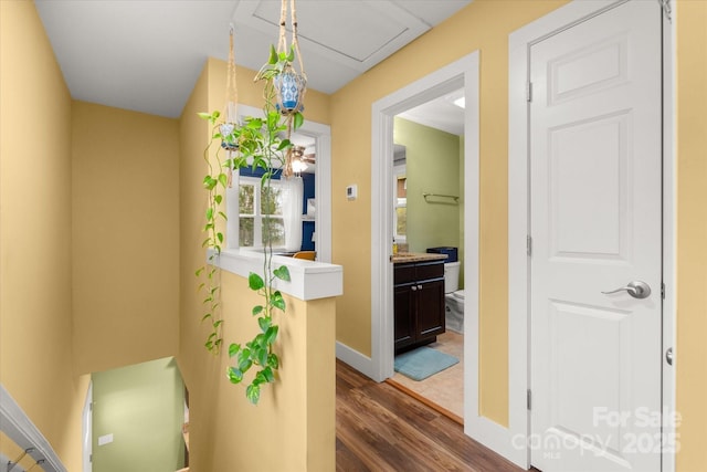 hall featuring baseboards and dark wood-style floors