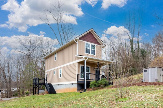 view of property exterior featuring an outbuilding, a shed, stairs, crawl space, and a lawn