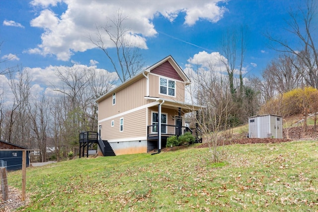 view of side of property featuring an outbuilding, a shed, a yard, stairs, and crawl space