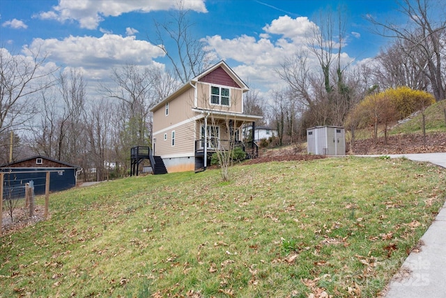 exterior space with a lawn, board and batten siding, an outdoor structure, and a shed