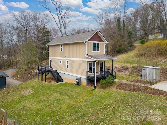 exterior space with crawl space, stairway, a yard, and roof with shingles