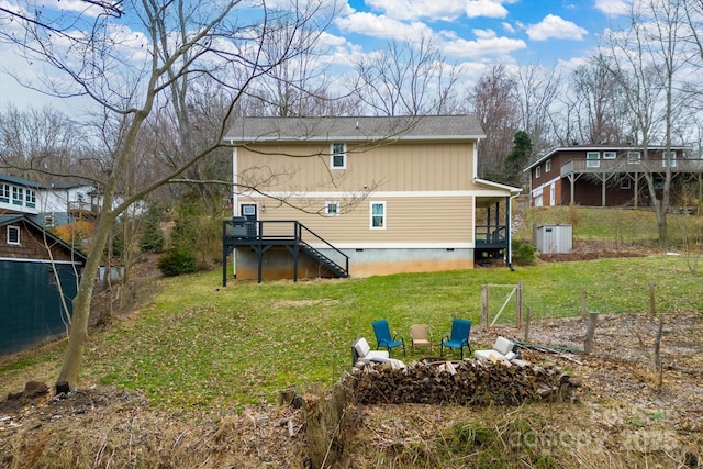 rear view of house featuring crawl space, a yard, and an outdoor fire pit