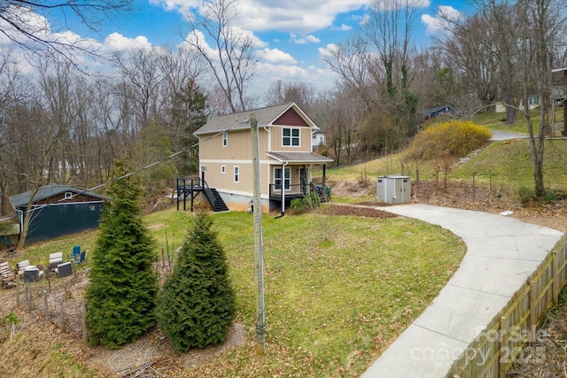 view of front of house with crawl space, driveway, and a front yard