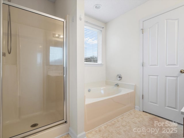 full bath with a garden tub, a shower stall, and tile patterned flooring