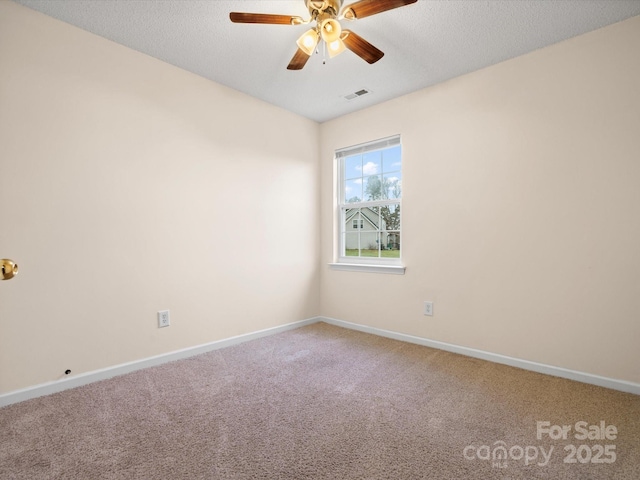 empty room featuring visible vents, baseboards, ceiling fan, and carpet flooring