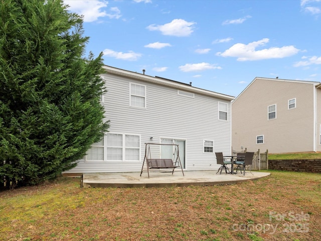 rear view of house featuring a patio and a lawn