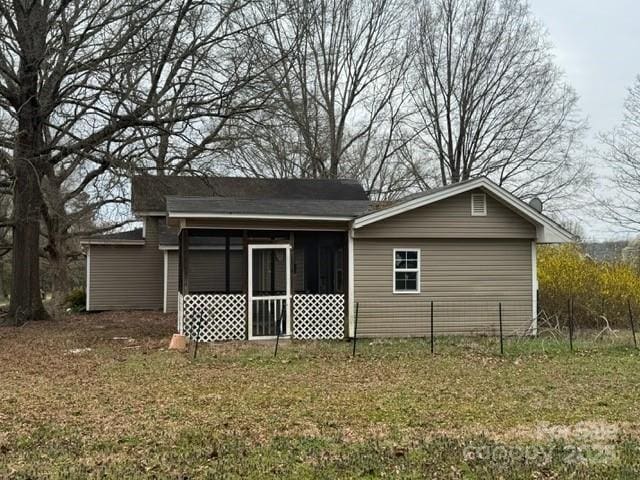 rear view of house featuring a sunroom