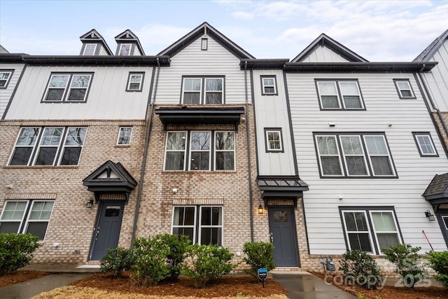 multi unit property featuring brick siding and board and batten siding