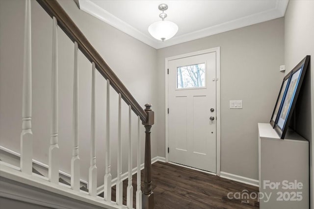 entrance foyer featuring stairs, dark wood-style floors, baseboards, and ornamental molding