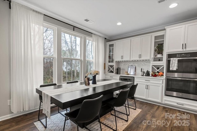 kitchen with glass insert cabinets, double oven, dark wood finished floors, and white cabinets