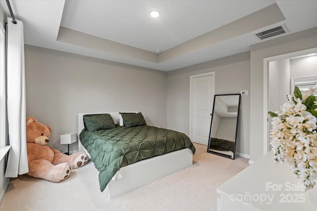 carpeted bedroom featuring visible vents, recessed lighting, a raised ceiling, and baseboards