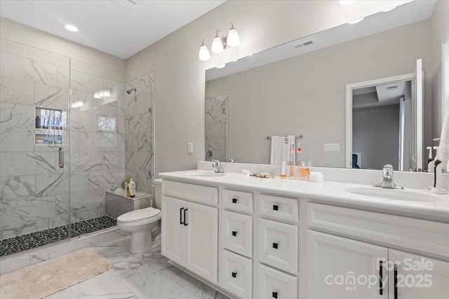 full bathroom with visible vents, marble finish floor, a shower stall, and a sink