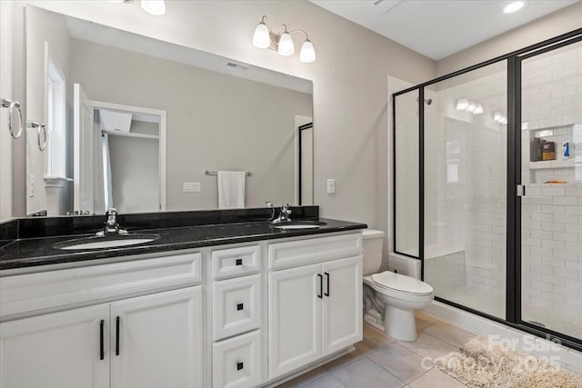 bathroom featuring tile patterned flooring, a shower stall, double vanity, and a sink