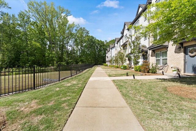 view of yard featuring a residential view and fence