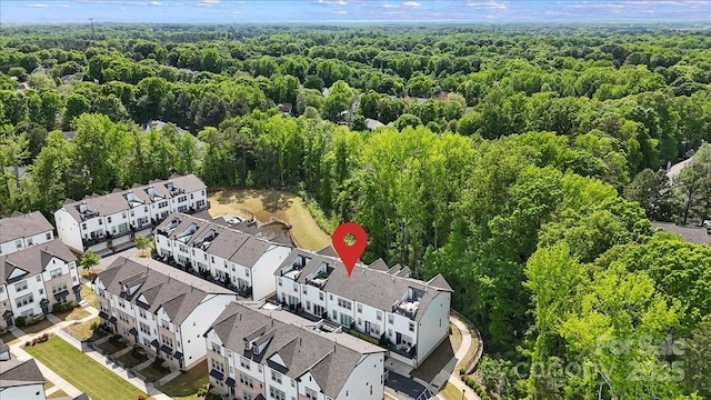 bird's eye view with a wooded view