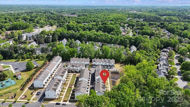 drone / aerial view with a residential view and a wooded view