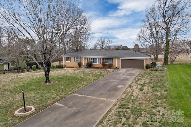 ranch-style house featuring a front yard, an attached garage, and concrete driveway