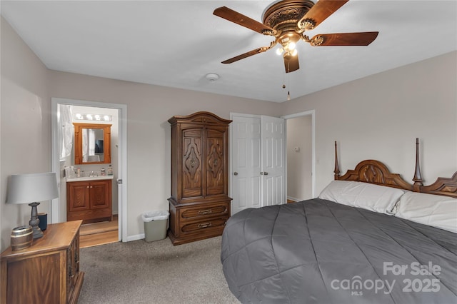 bedroom with carpet flooring, a ceiling fan, baseboards, and ensuite bathroom