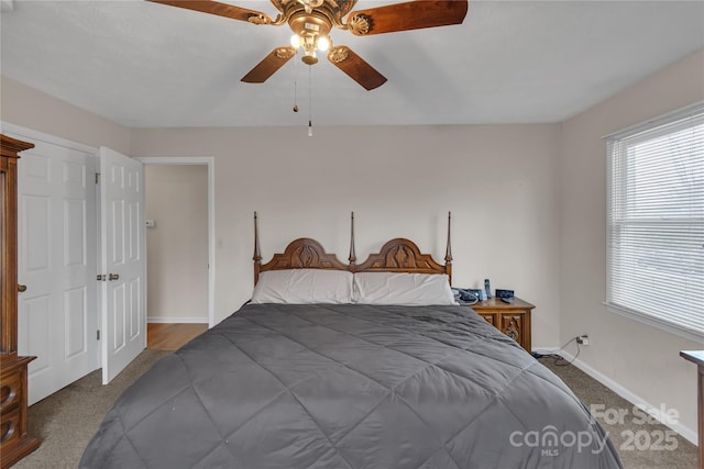 bedroom with multiple windows, baseboards, and carpet floors