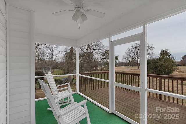 sunroom / solarium with a wealth of natural light and a ceiling fan