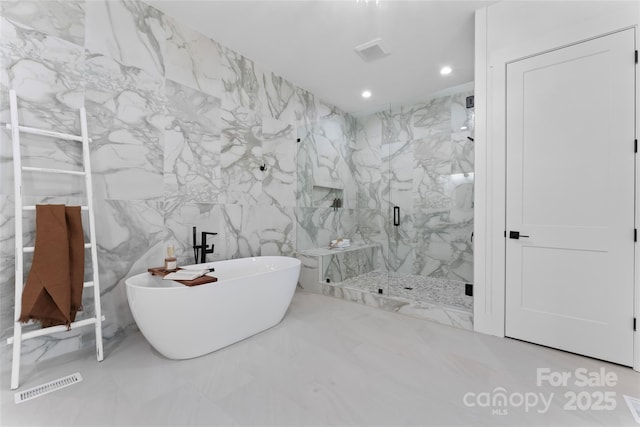bathroom with marble finish floor, a marble finish shower, visible vents, recessed lighting, and a freestanding tub