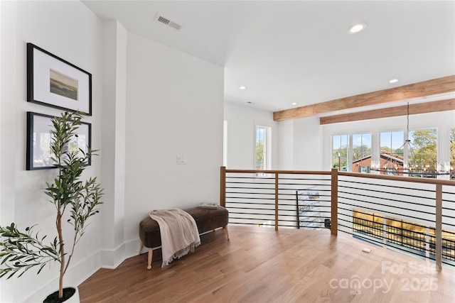 corridor featuring recessed lighting, baseboards, visible vents, and wood finished floors