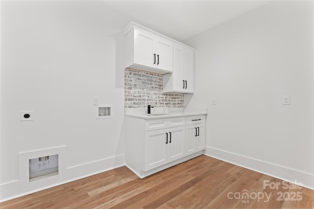 laundry room with light wood-style flooring, washer hookup, baseboards, and electric dryer hookup