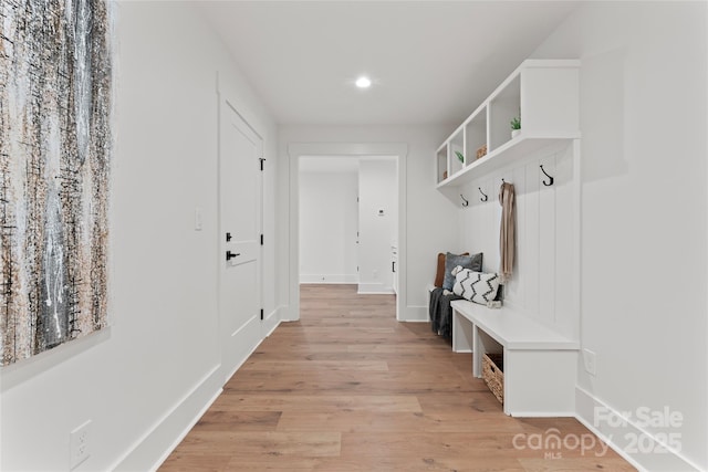 mudroom with light wood-style floors, baseboards, and recessed lighting