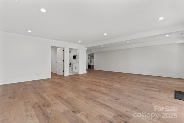spare room featuring light wood-style flooring and recessed lighting
