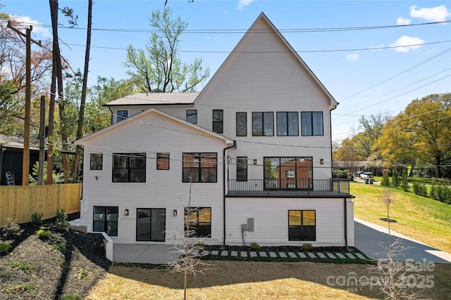 rear view of house with fence
