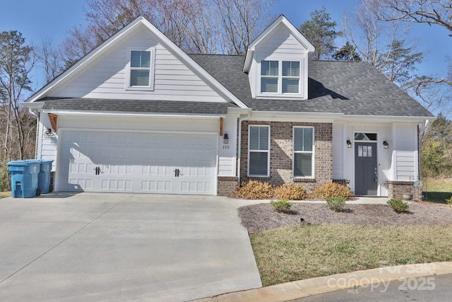 view of front facade featuring driveway, brick siding, roof with shingles, and an attached garage