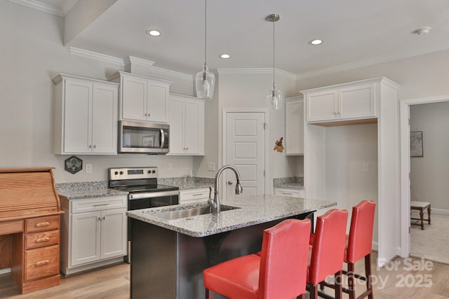 kitchen featuring a sink, light wood-style floors, white cabinetry, and stainless steel appliances