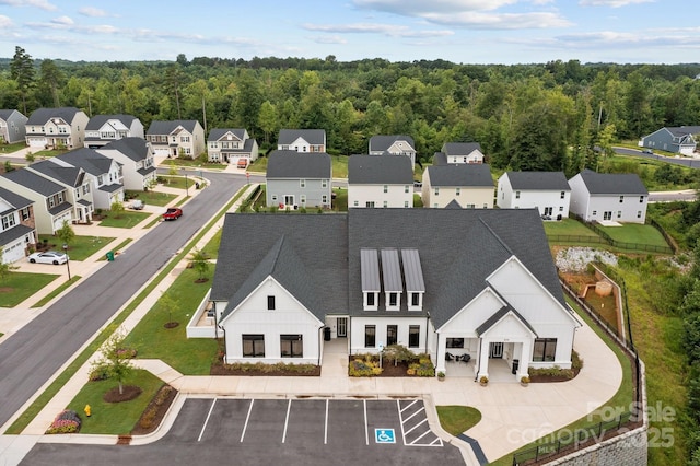 aerial view with a residential view and a wooded view