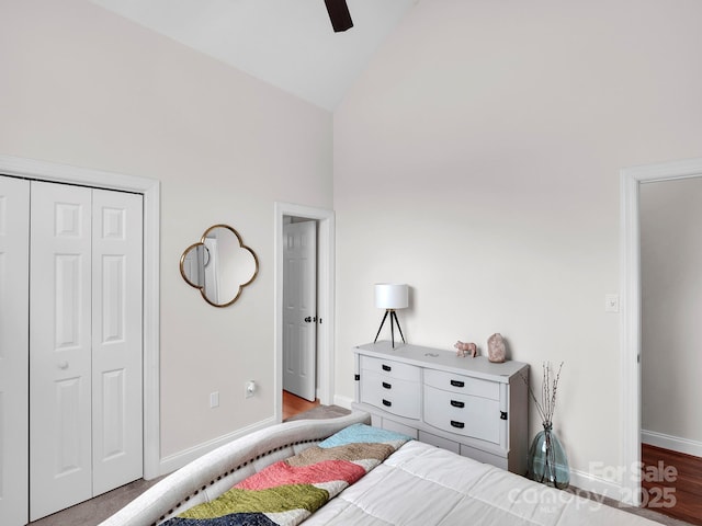 bedroom featuring ceiling fan, baseboards, wood finished floors, a closet, and high vaulted ceiling