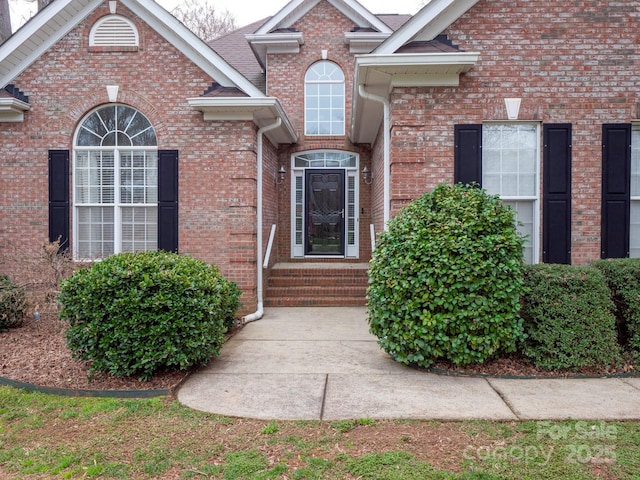 property entrance featuring brick siding