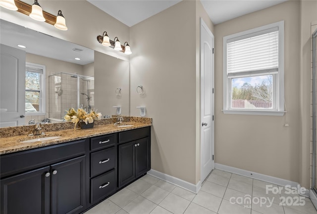 bathroom with double vanity, tile patterned flooring, a shower stall, and a sink