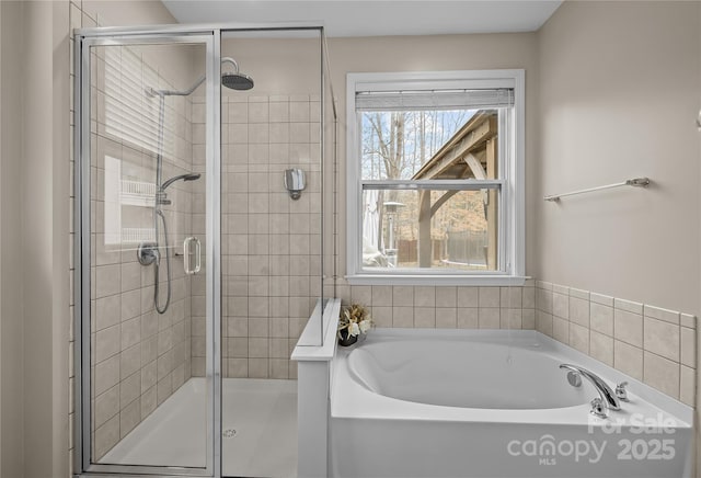 full bath featuring a shower stall and a garden tub