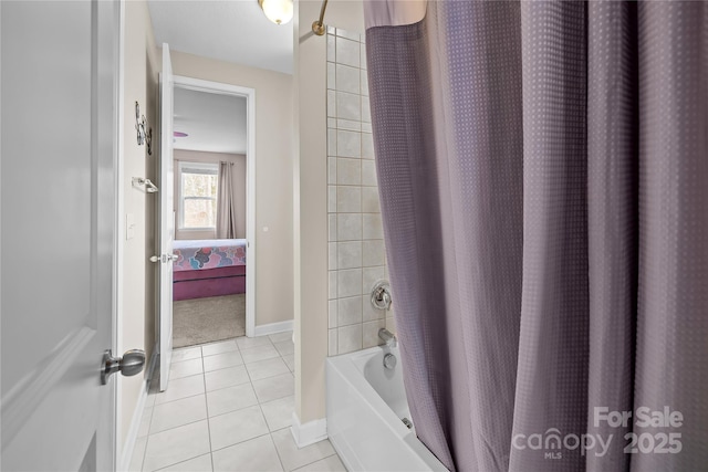 full bath with tile patterned flooring, shower / tub combo, baseboards, and connected bathroom